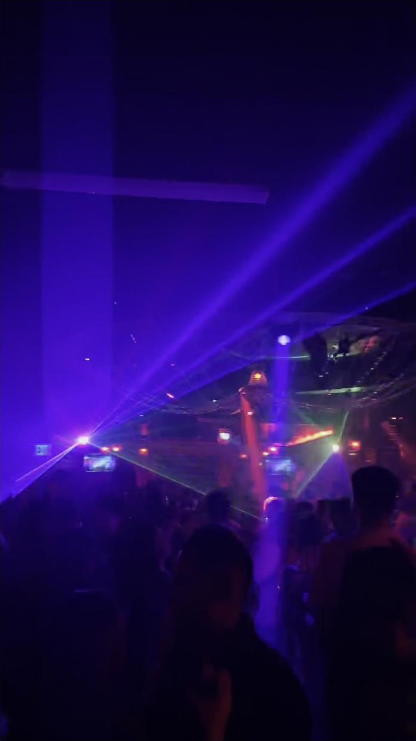 Crowd under blue lasers on the Sevilla dance floor